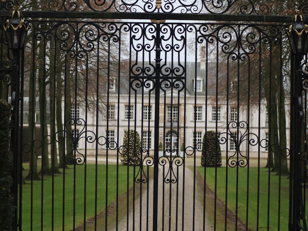 Ornate iron driveway gate at a property entrance