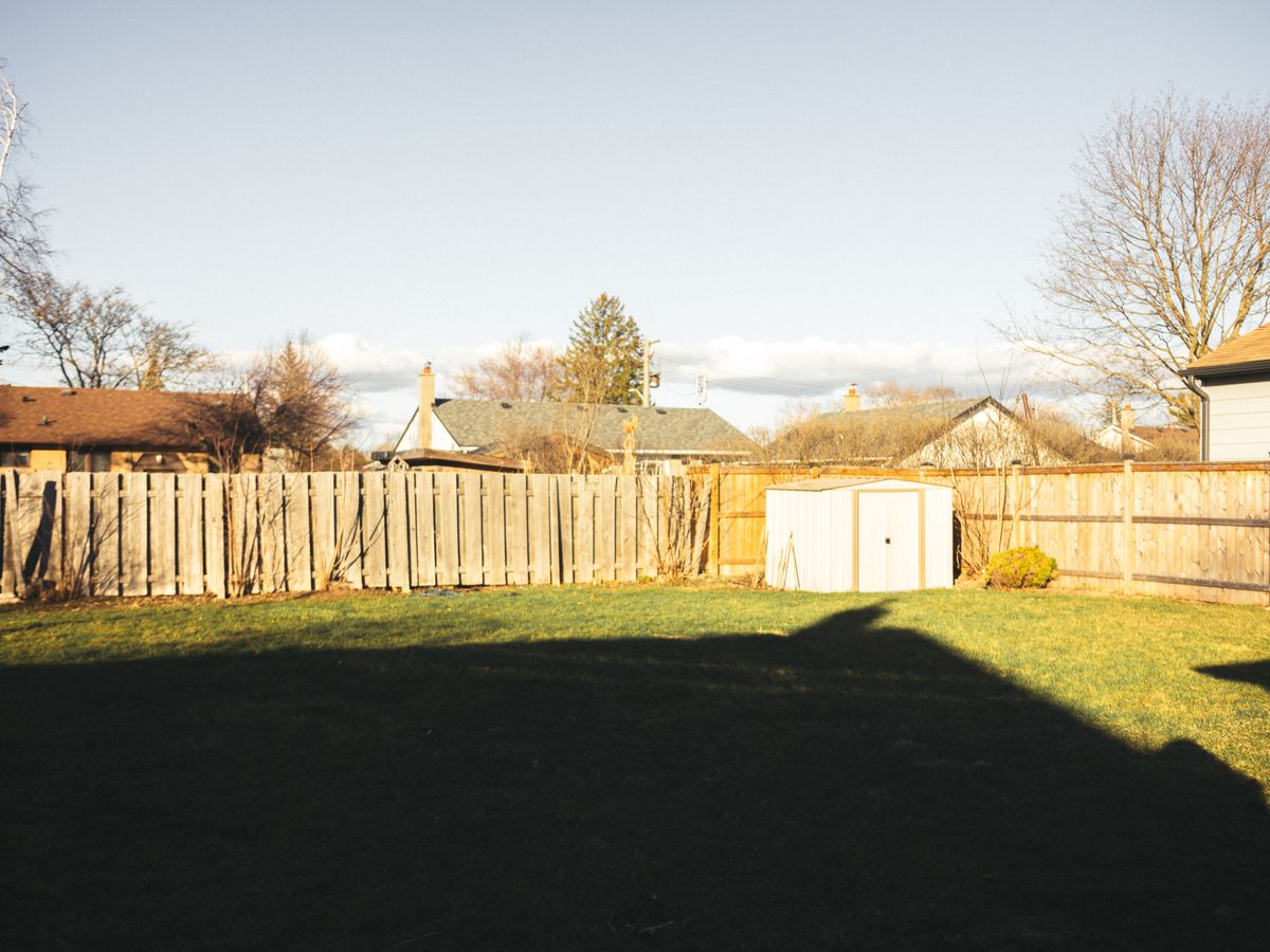 Wood privacy fence enclosing a residential backyard