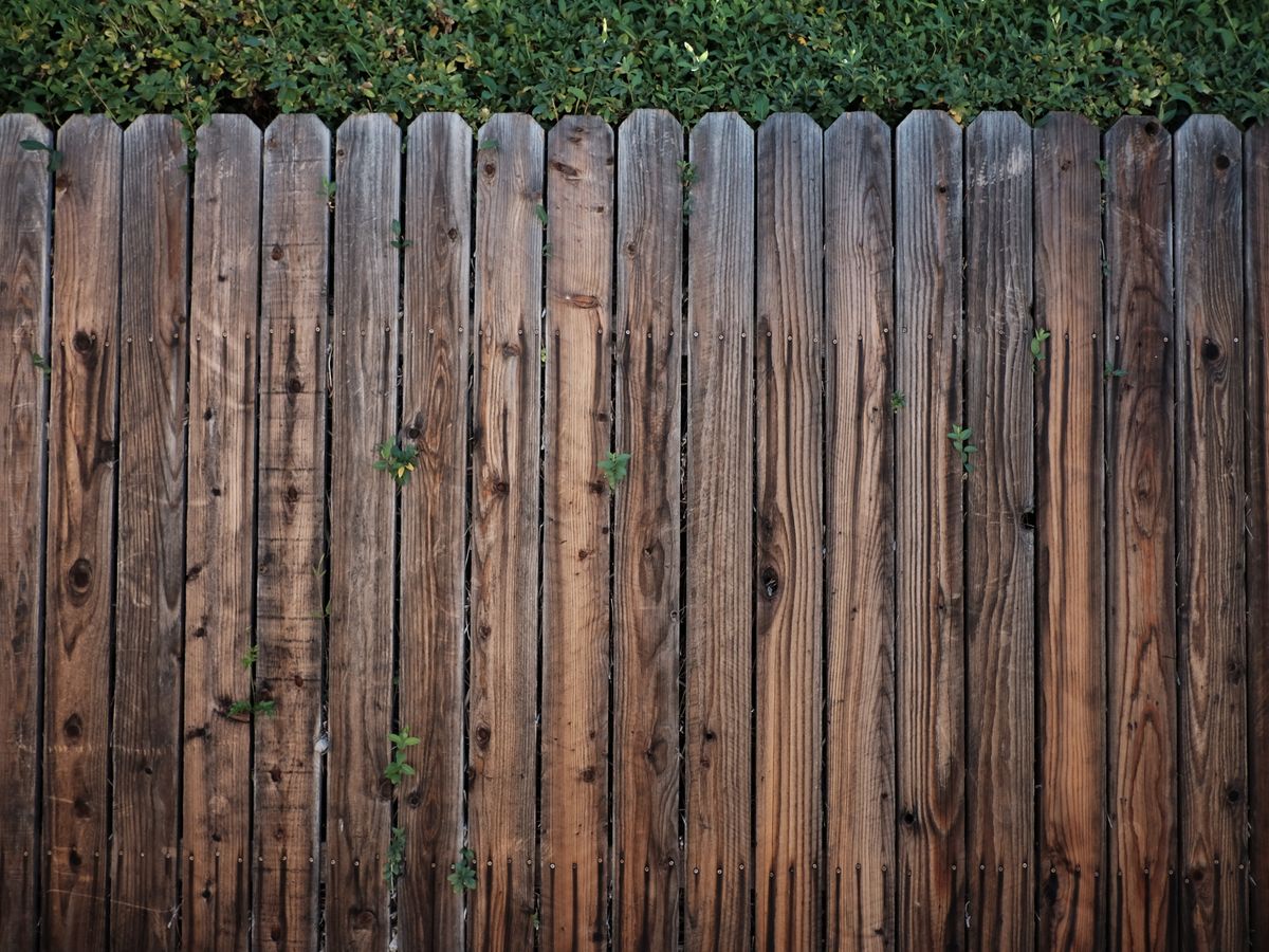 Weathered cedar privacy fence with vertical boards